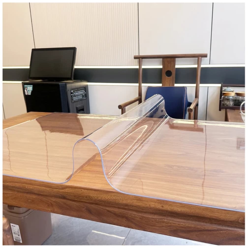 Clear PVC table protector fitted on a desk; exact size is stated in the listing